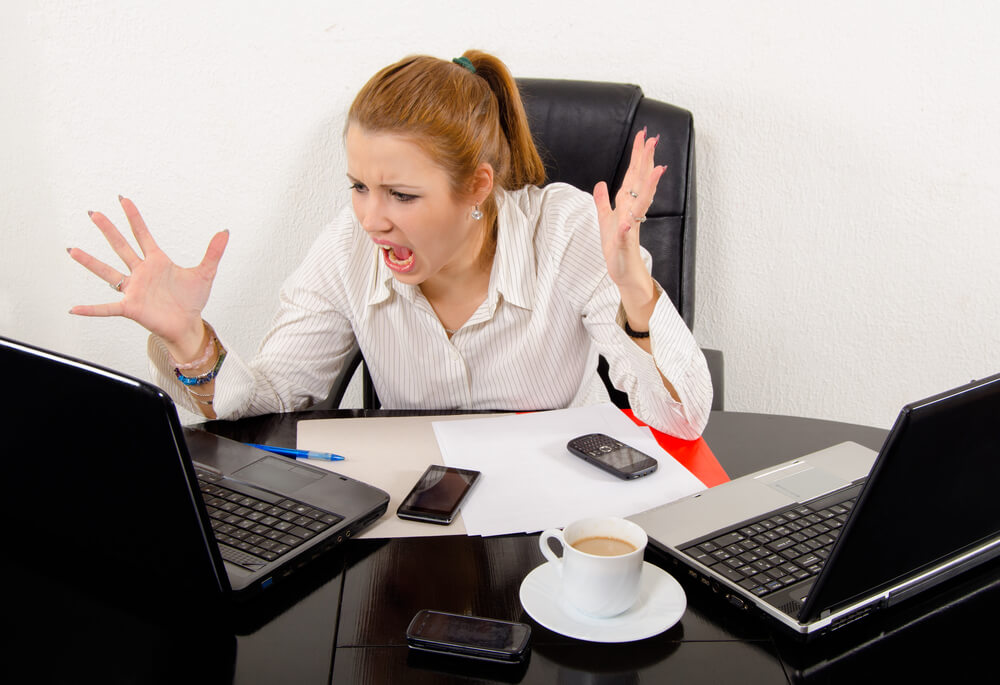 young executive experiencing frustration from technology overload